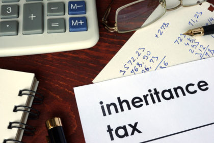 Inheritance tax on paper with calculator and pen